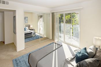 a bedroom with a bed and a mirror at Dronfield Astoria Apartments, Sylmar, California, 91342